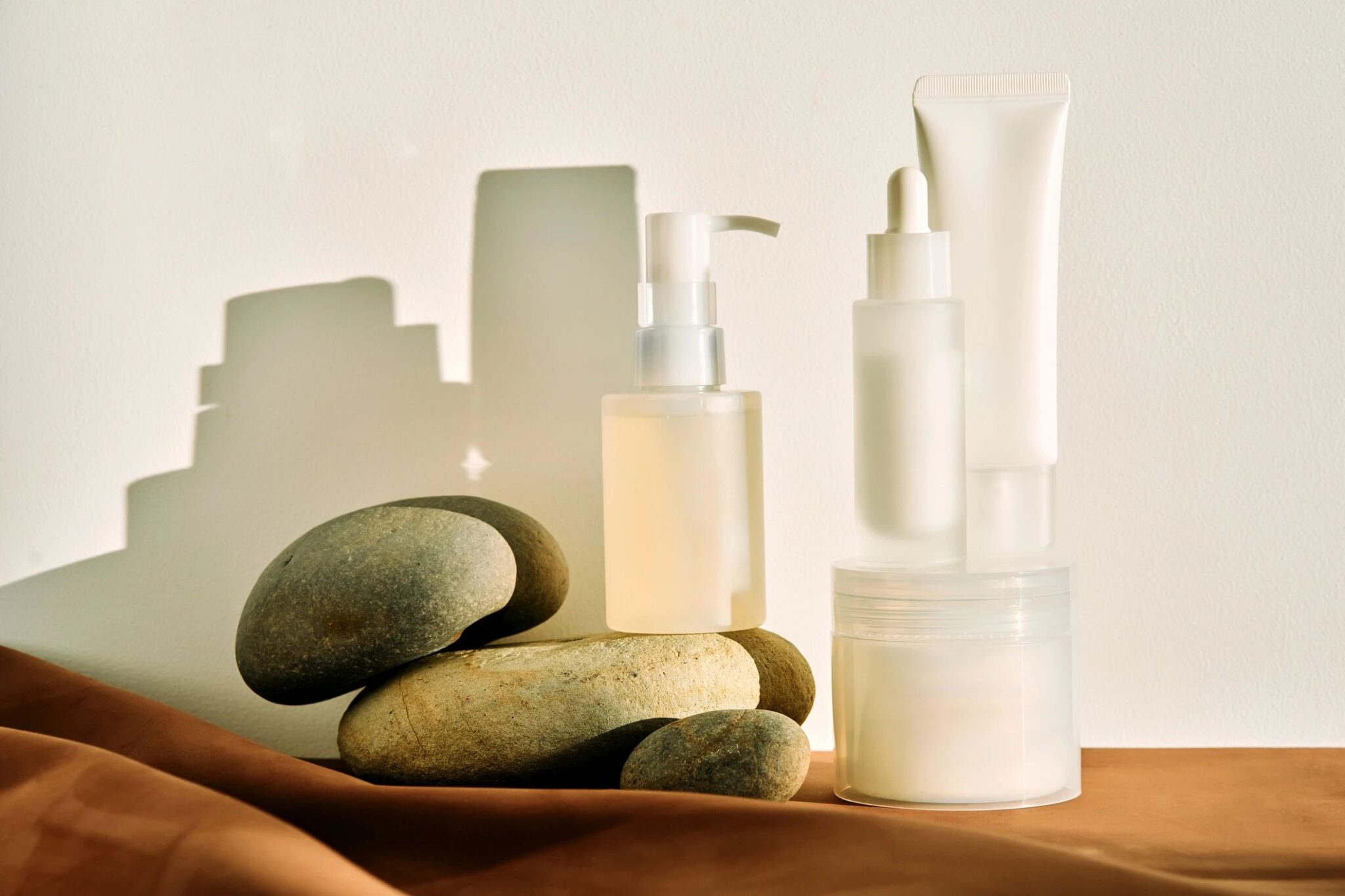 Skincare products with stones and shadows